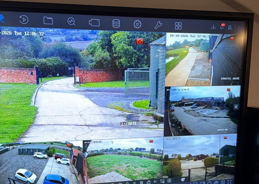 Large screen showing live CCTV views of a gated site and its approach roads