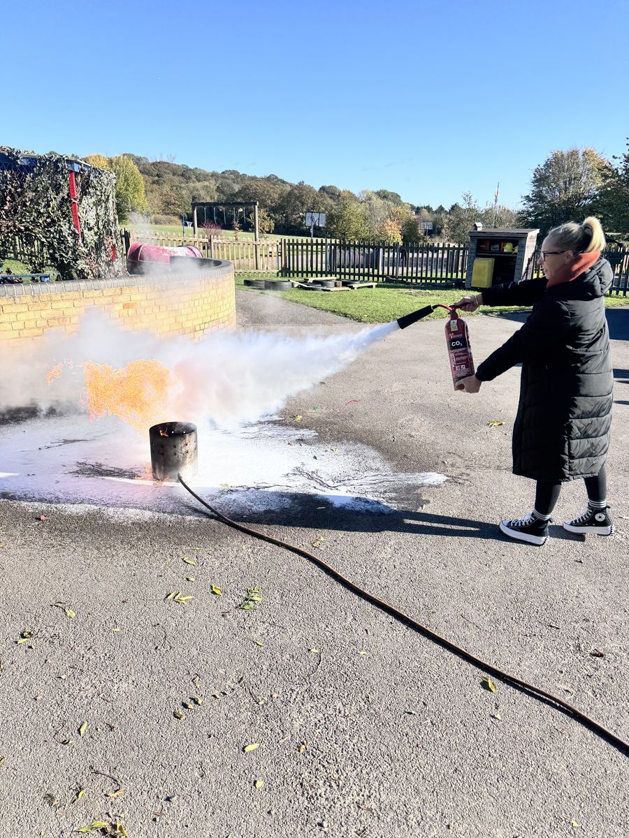 Hands-on fire extinguisher training on a controlled live fire