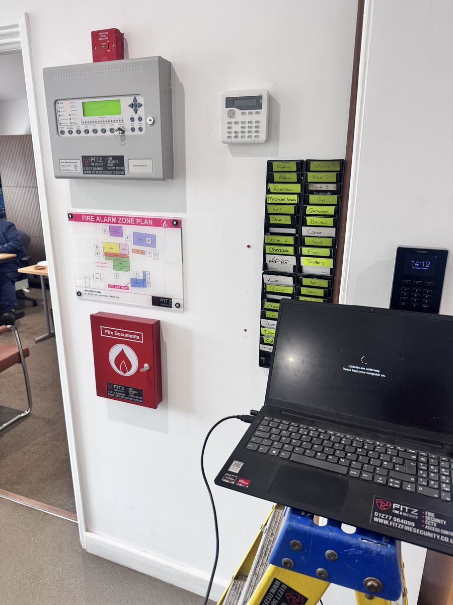 Fitz engineer commissioning a fire alarm panel with a laptop