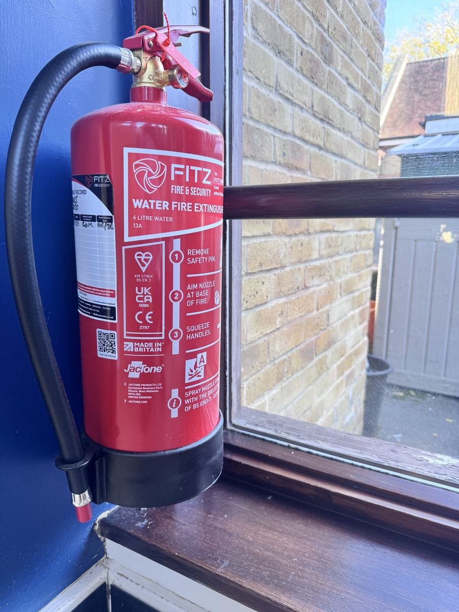 FITZ FIRE & SECURITY water fire extinguisher mounted on a wall